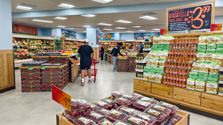 Shoppers move through a Trader Joe's next to produce and a pasta display