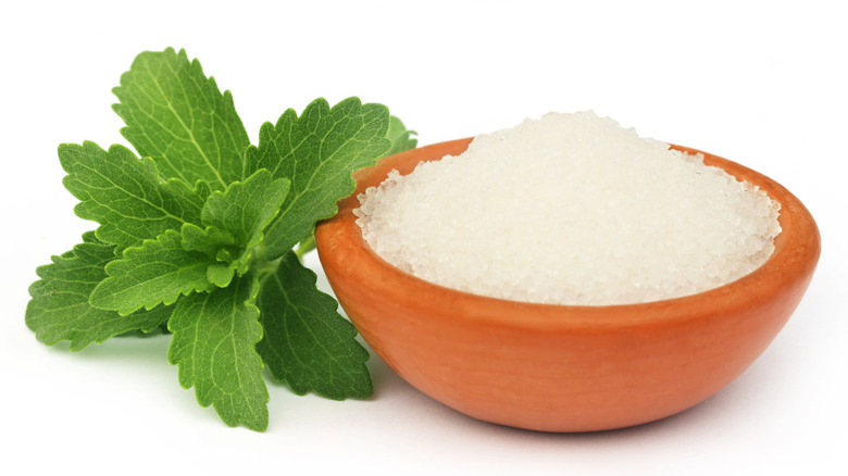 A bowl of granulated stevia in a wooden bowl