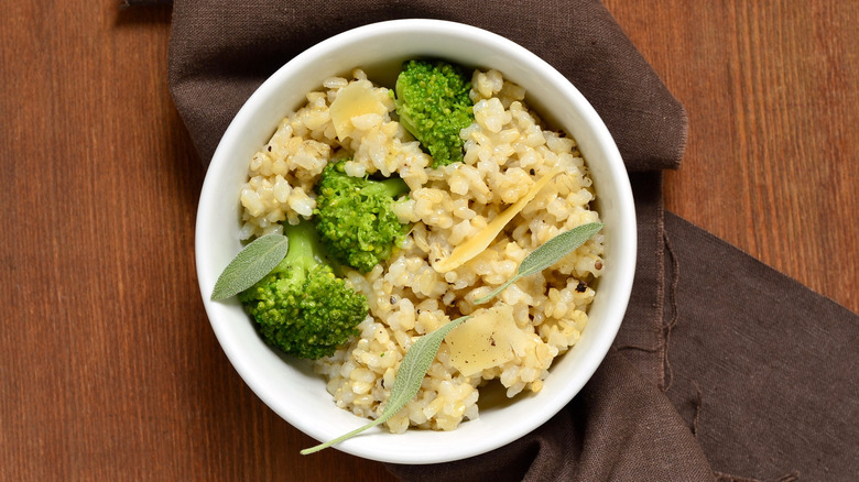 White bowl of cheesy broccoli rice