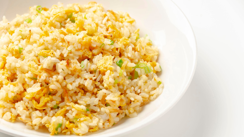 White bowl of fried rice with egg
