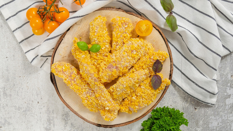 Plate of raw, breaded chicken tenders