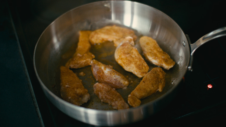 Chicken tenders close together in sauté pan