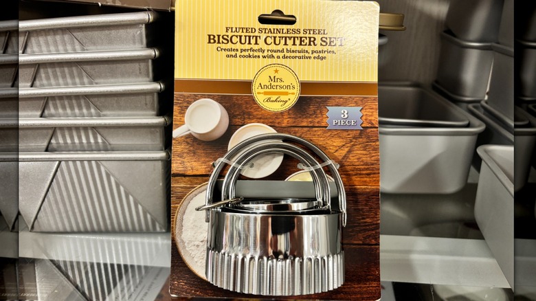 A set of three biscuit cutters is on a shelf.