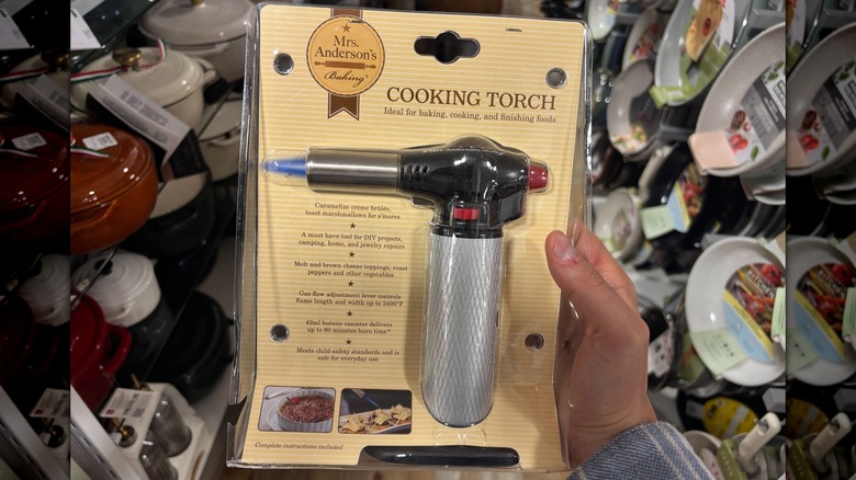 A cooking torch in its package is in a store.