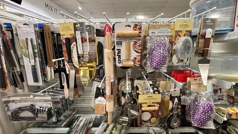 Baking tools are hanging on a rack in HomeGoods.