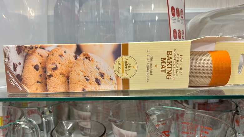 A silicone baking mat is lying horizontally on a shelf.