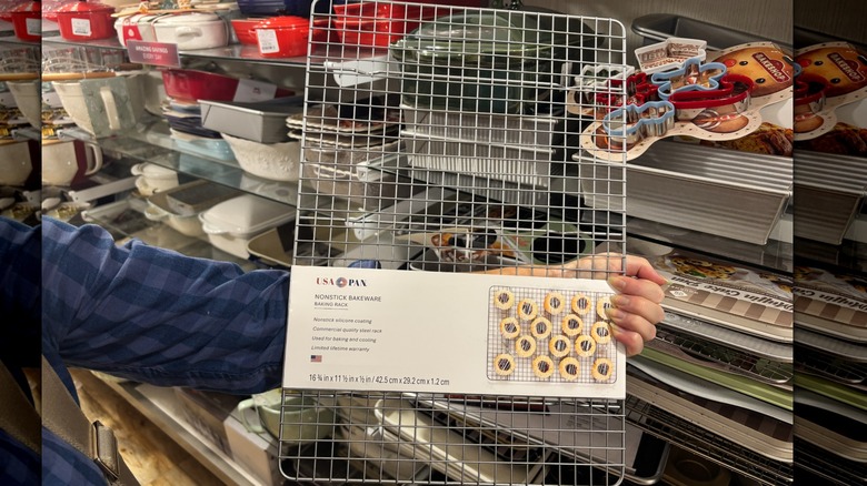 A person holding up a wire baking rack in HomeGoods