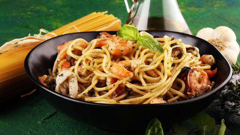 A bowl of pasta with mixed seafood