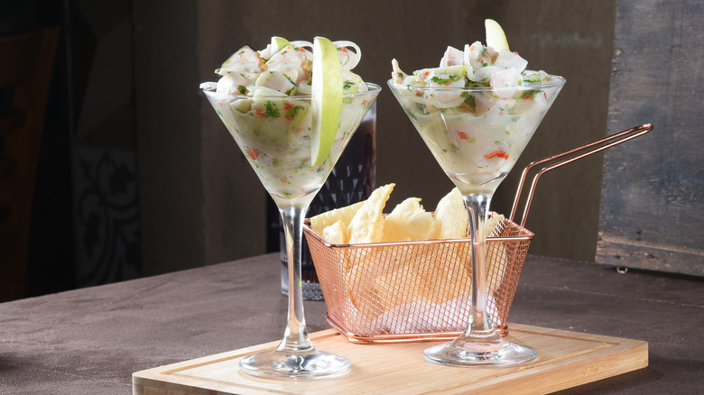 Two martini glasses of Ceviche with tortilla chips