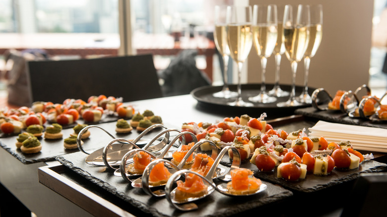 platter of hors d'oeuvres with glasses of sparkling wine beside them