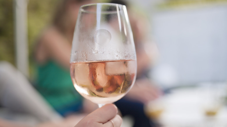 close up of a glass of rosé with ice in the glass