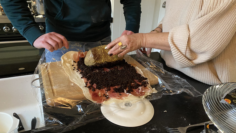 man and woman rolling beef wellington