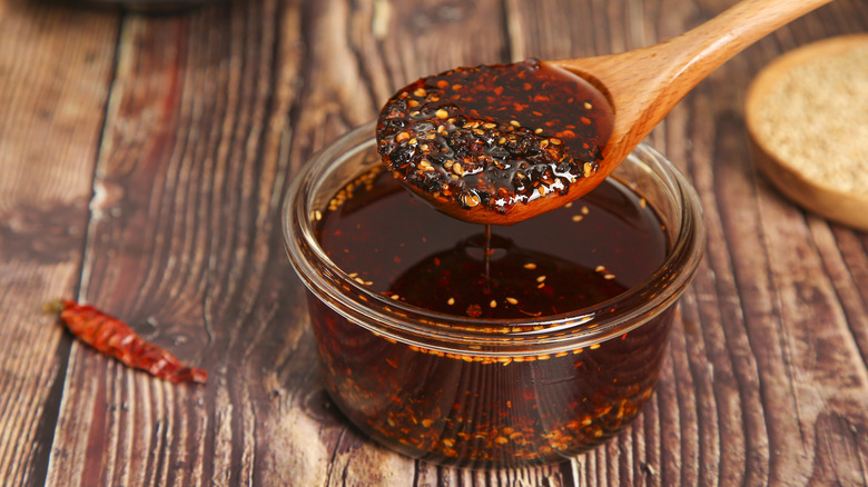 Spoonful of chili oil condiment from a jar