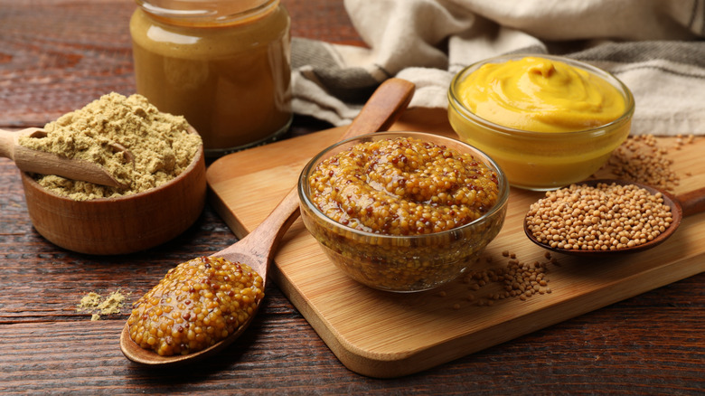 Varieties of mustard condiments on display in bowls