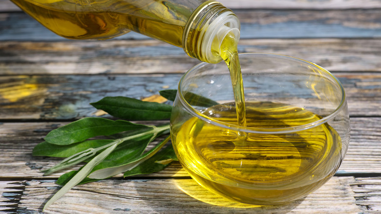 Olive oil being poured into bowl for use as a condiment
