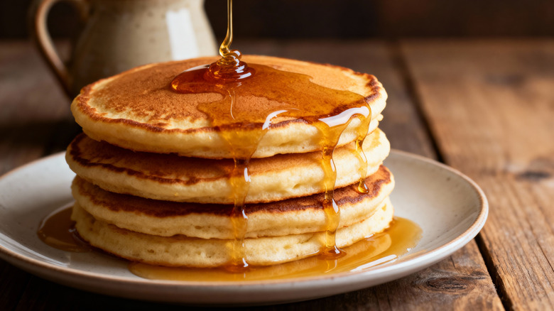 Plate of pancakes dripping with syrup