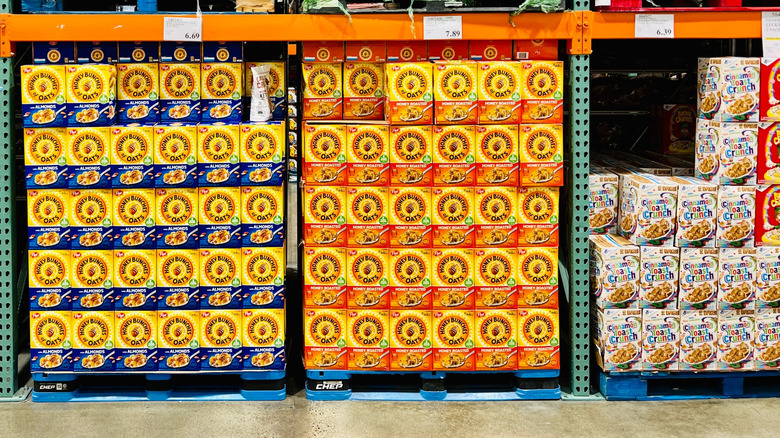 many stacks of multiple varieties of cereal boxes along the aisle at costco