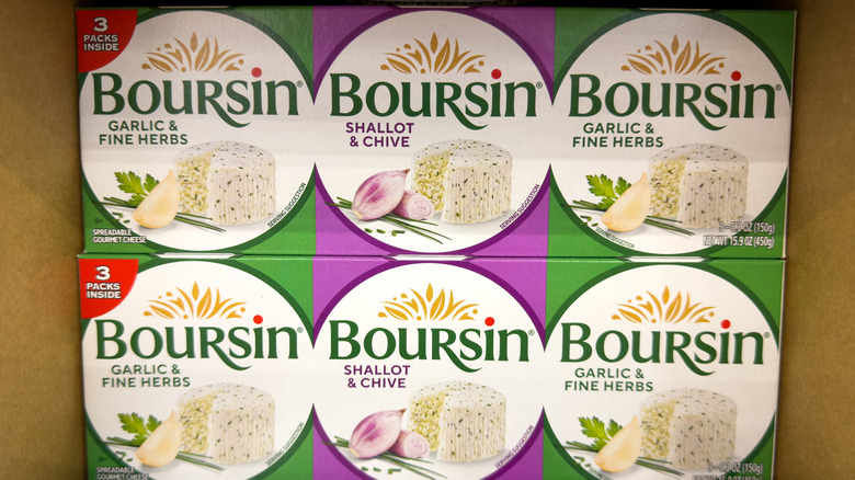 several packs of boursin garlic & herb cheese in box