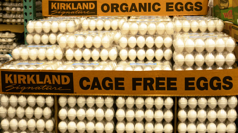 stacks of egg cartons with signage for kirkland signature organic and cage free egss