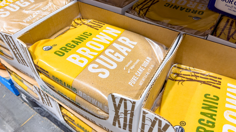 several bags of organic brown sugar stacked in boxes at costco