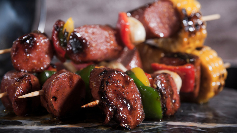 Skewers stacked with sliced hot dogs and veggies