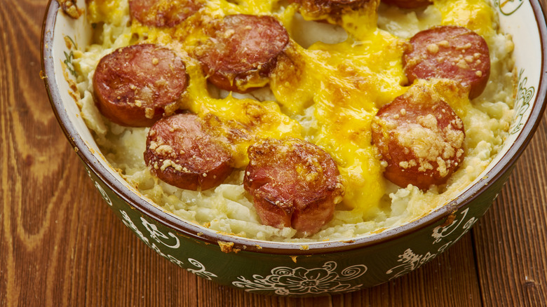 Cheesy potato casserole with sliced hot dogs