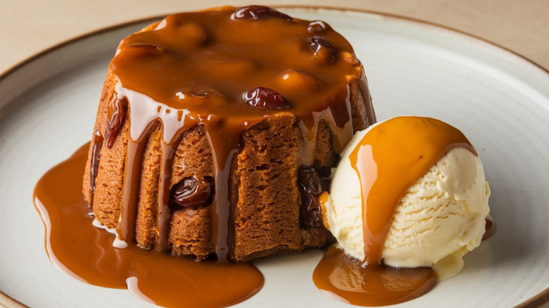 Stick toffee pudding and vanilla ice cream on a white plate