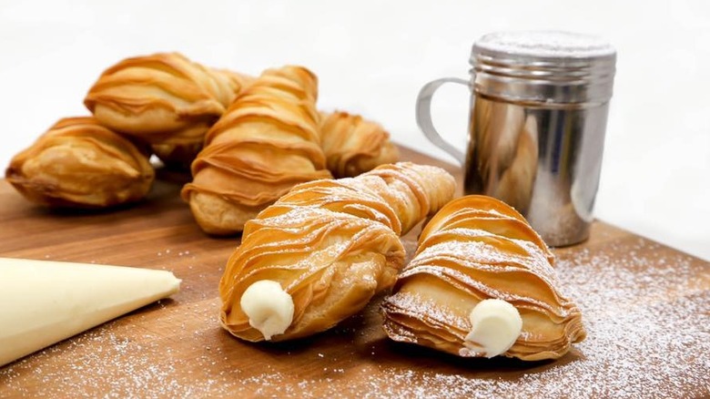Lobster tail pastries on a wooden cutting board