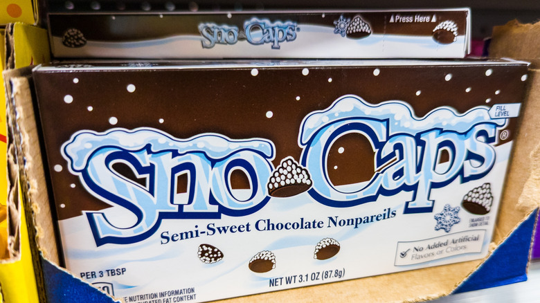 A box of Sno-Caps sits on a store display shelf