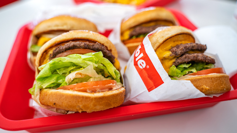 Red fast food tray filled with burgers