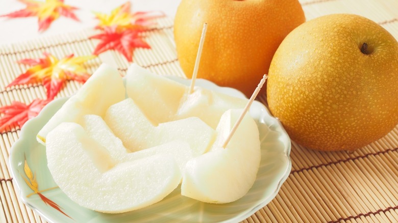 Whole and sliced Asian pears.
