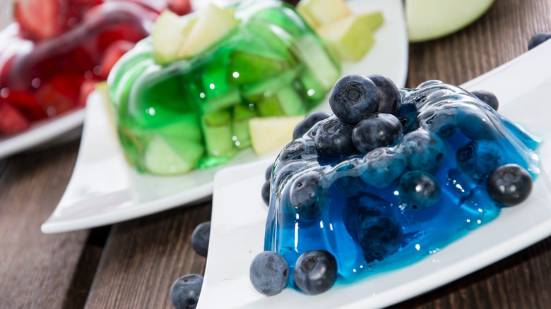 A trio of molded gelatin desserts with fruit.