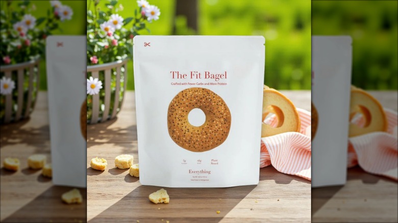 A bag of The Fit Bagel Everything Bagels in an outdoor setting with flowers and greenery.