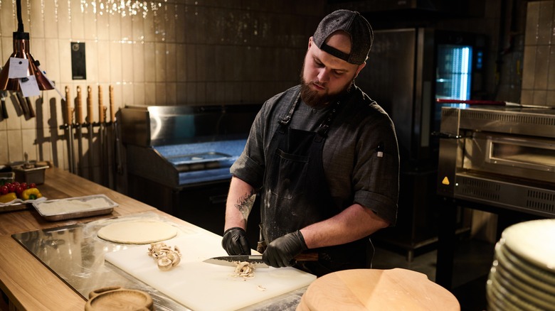 Chef chopping mushrooms