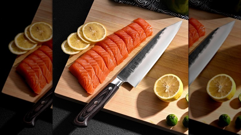 8.27 Inch Japanese Kitchen Knife, Commercial Chef Knife alongside sliced salmon.