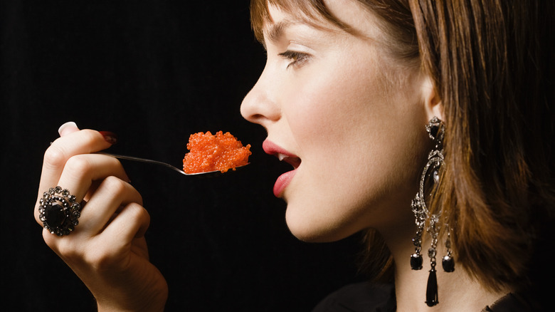 woman about to eat spoonful caviar