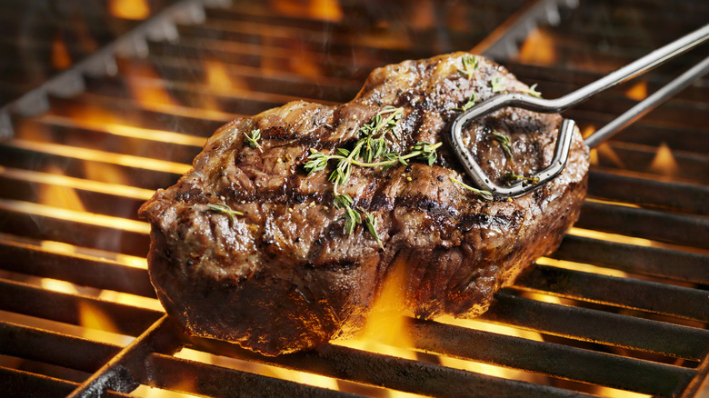 Seared steak over flaming grill