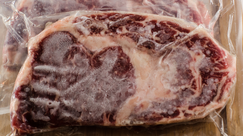 Frozen steak in vacuum-sealed plastic