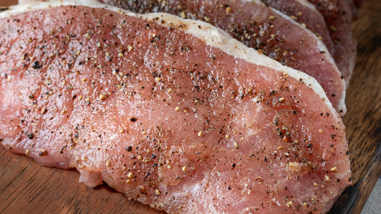 close up of seasoned pork chop with moisture on surface