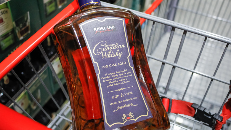 a bottle of Kirkland Signature Canadian Whisky in a cart