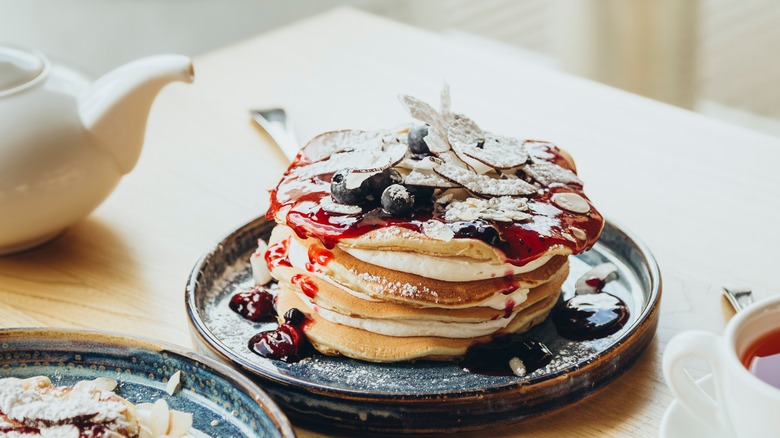 Plate of pancakes topped with blueberry compote