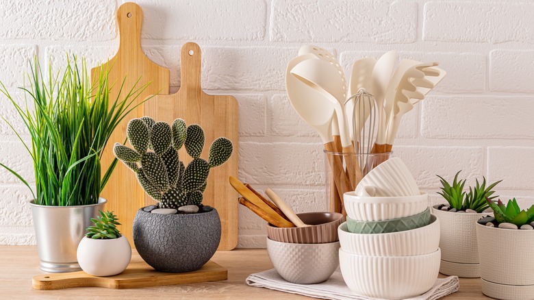 kitchen utensils in a glass jar resting on a counter