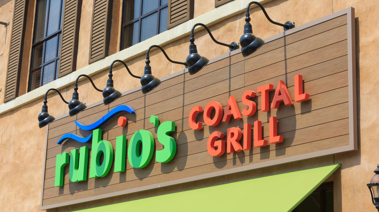 Lamplit Rubio's Coastal Grill sign below shuttered windows