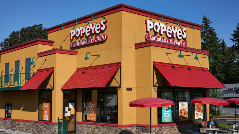 Popeyes restaurant with customers dining outside