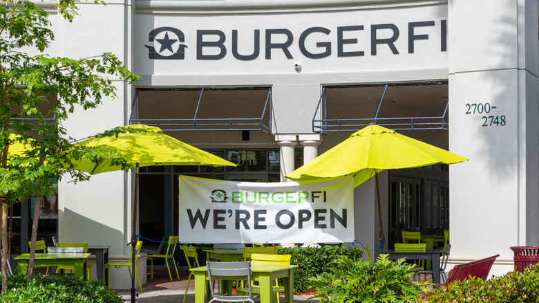 BurgerFi restaurant promoting "We're Open" with sign