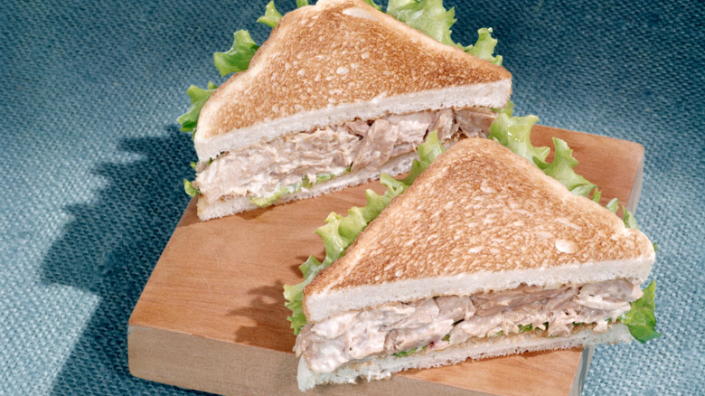 tuna salad sandwiches on a cutting block