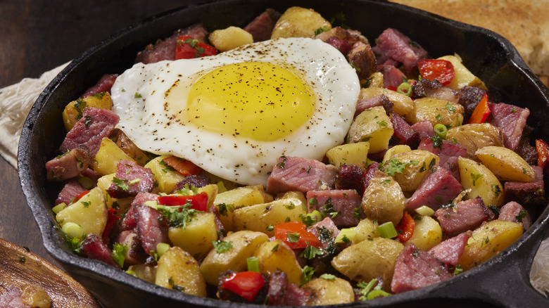 corned beef hash with egg in a frying pan
