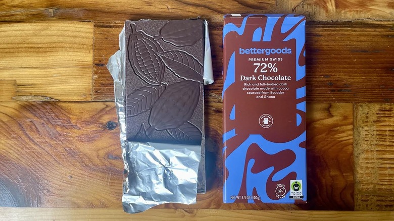 A Bettergoods Premium Swiss 72% Dark Chocolate Bar lying on a wooden table top