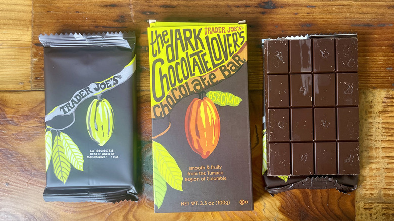 An unwrapped Trader Joe's The Dark Chocolate Lover's 85% Chocolate Bar lying on a wooden table top