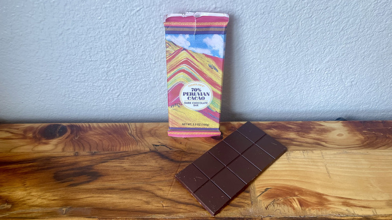 An unwrapped Trader Joe's 70% Peruvian Cacao Dark Chocolate Bar on a wooden table top